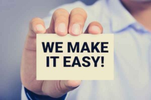 We,Make,It,Easy!,Message,On,The,Card,Shown,By A person in a white shirt holds a card with bold black text reading "We Make It Easy!" The tone is confident and reassuring, emphasizing simplicity.